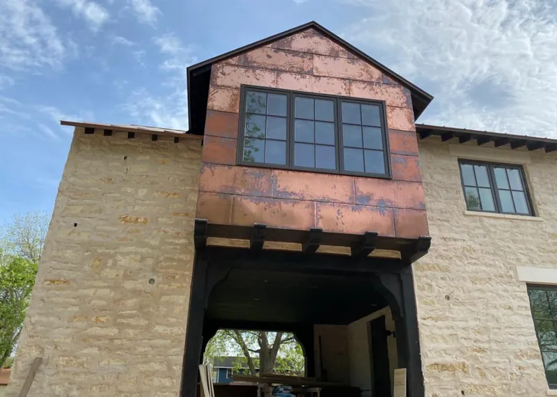 Copper metal panel facade on a stone building for Skylight Installation in Salem Lakes