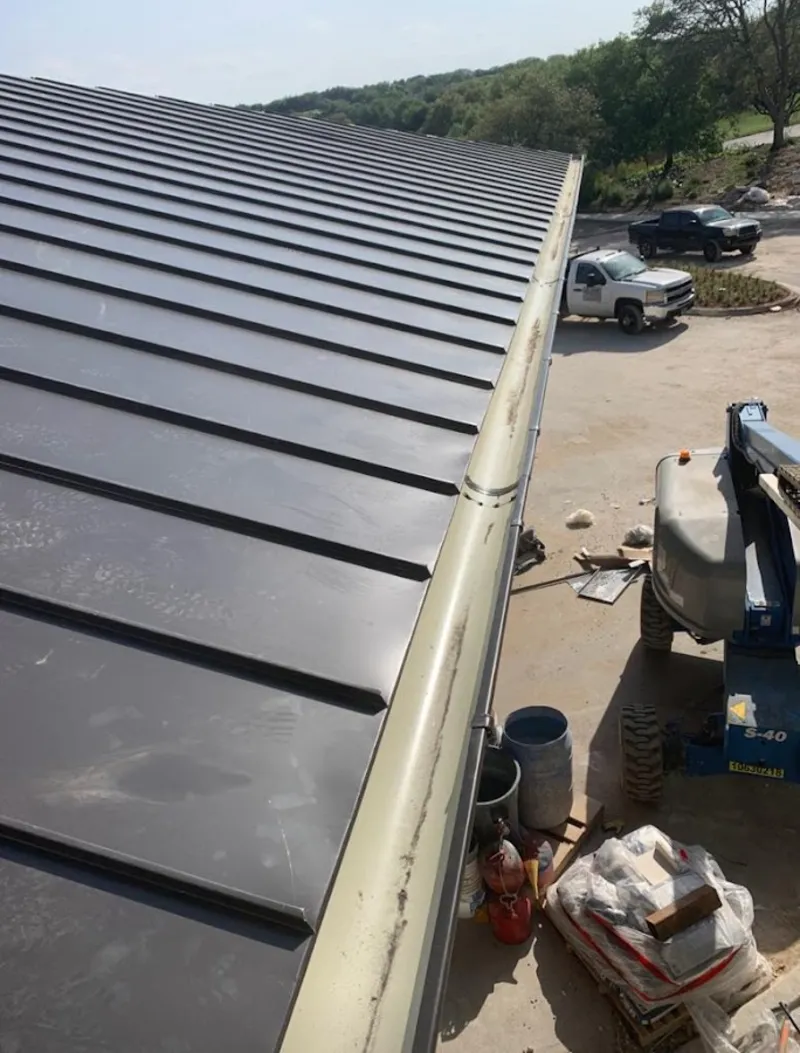 Standing seam panel and gutter detail on a metal roofing jobsite in Salem Lakes